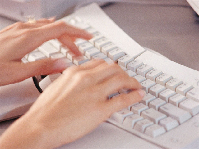 employee’s hands typing on a keyboard